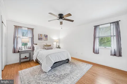 a bedroom with a large bed and a ceiling fan