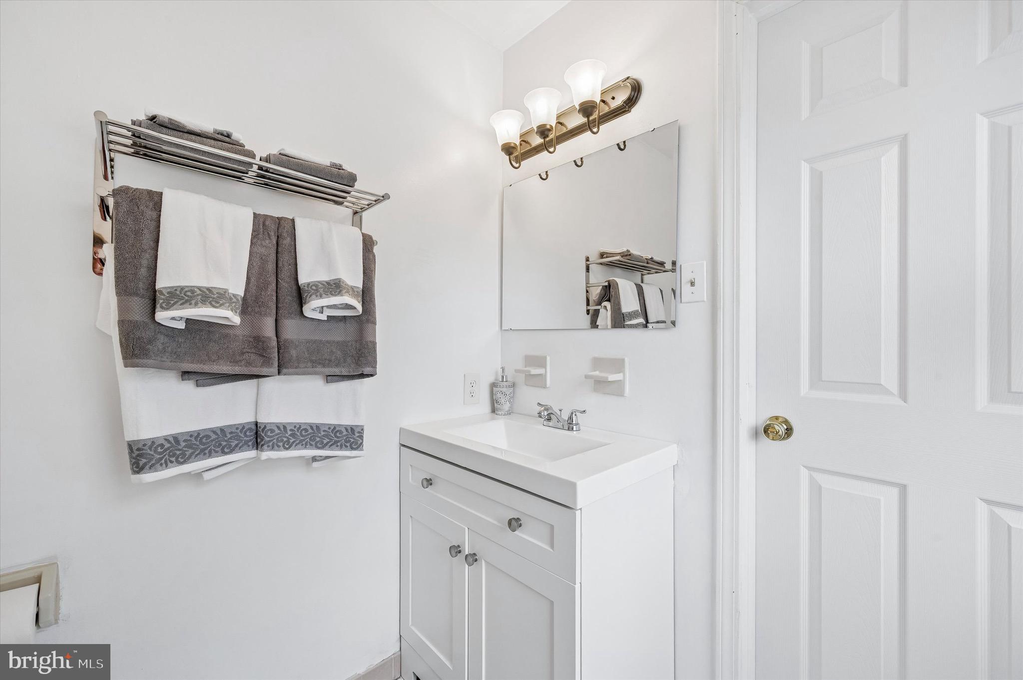 22 East Belair Road Ridley Park, PA 19078 - Photo 22 of 36 a bathroom with a sink a mirror and shower
