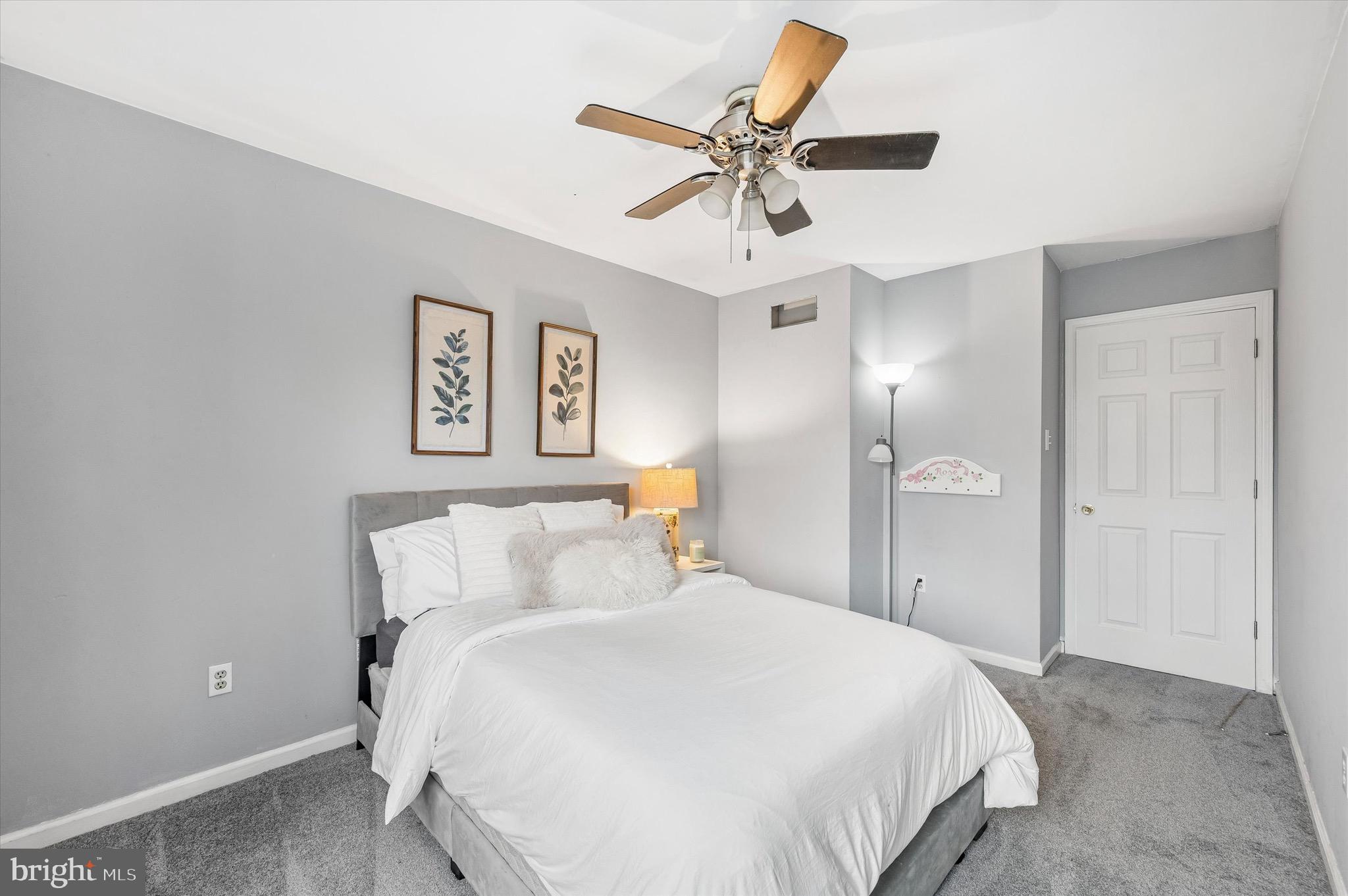 22 East Belair Road Ridley Park, PA 19078 - Photo 29 of 36 a bedroom with a large bed and a ceiling fan