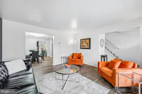 a living room with furniture a rug and a large window
