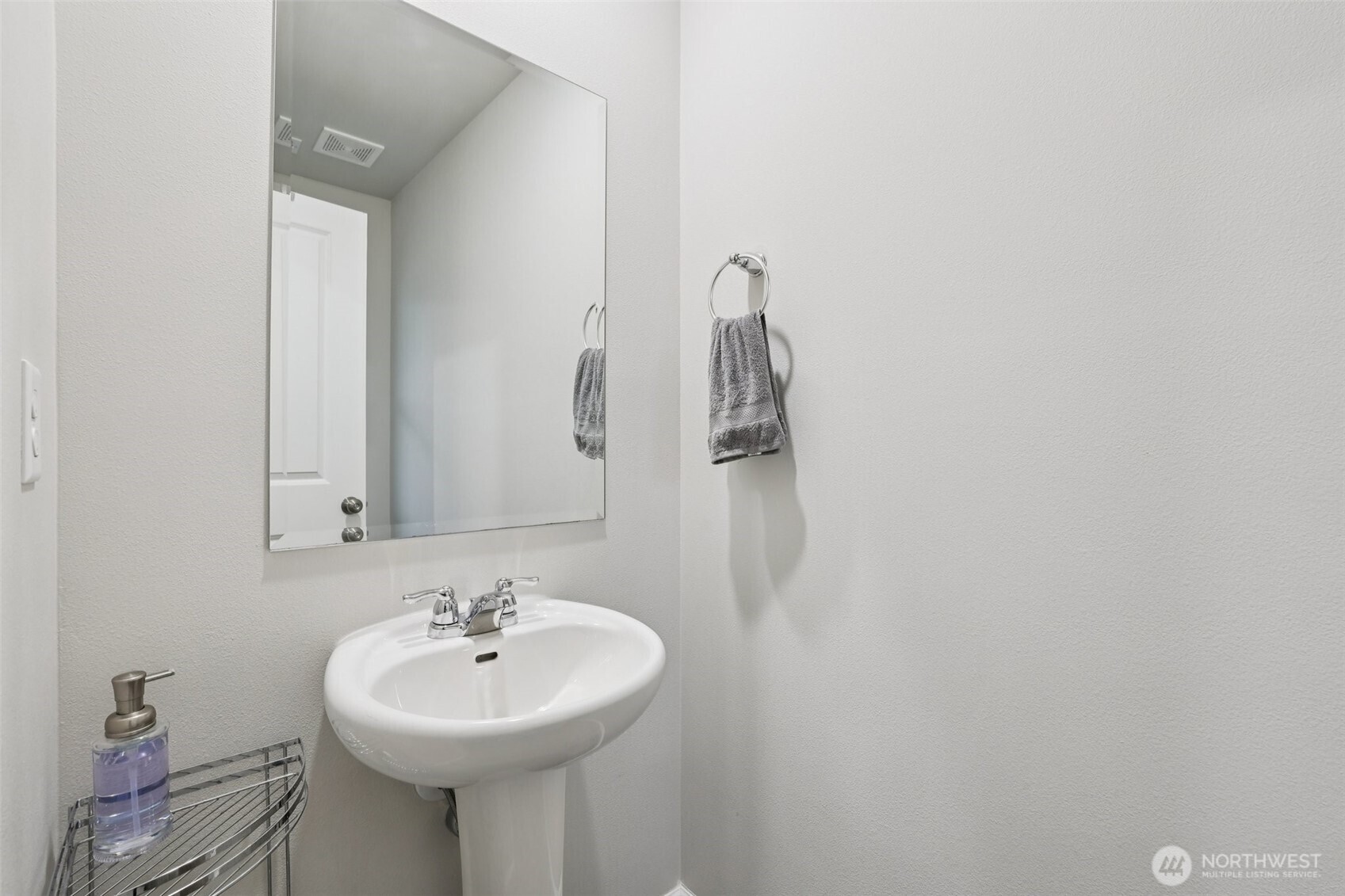 1132 15th Avenue Sultan, WA 98294 - Photo 11 of 25 a bathroom with a sink a mirror and a shower