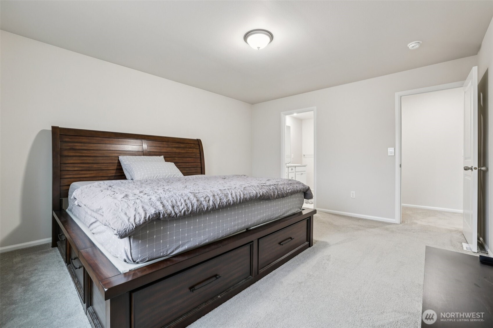 1132 15th Avenue Sultan, WA 98294 - Photo 16 of 26 a bedroom with a bed and a cabinets