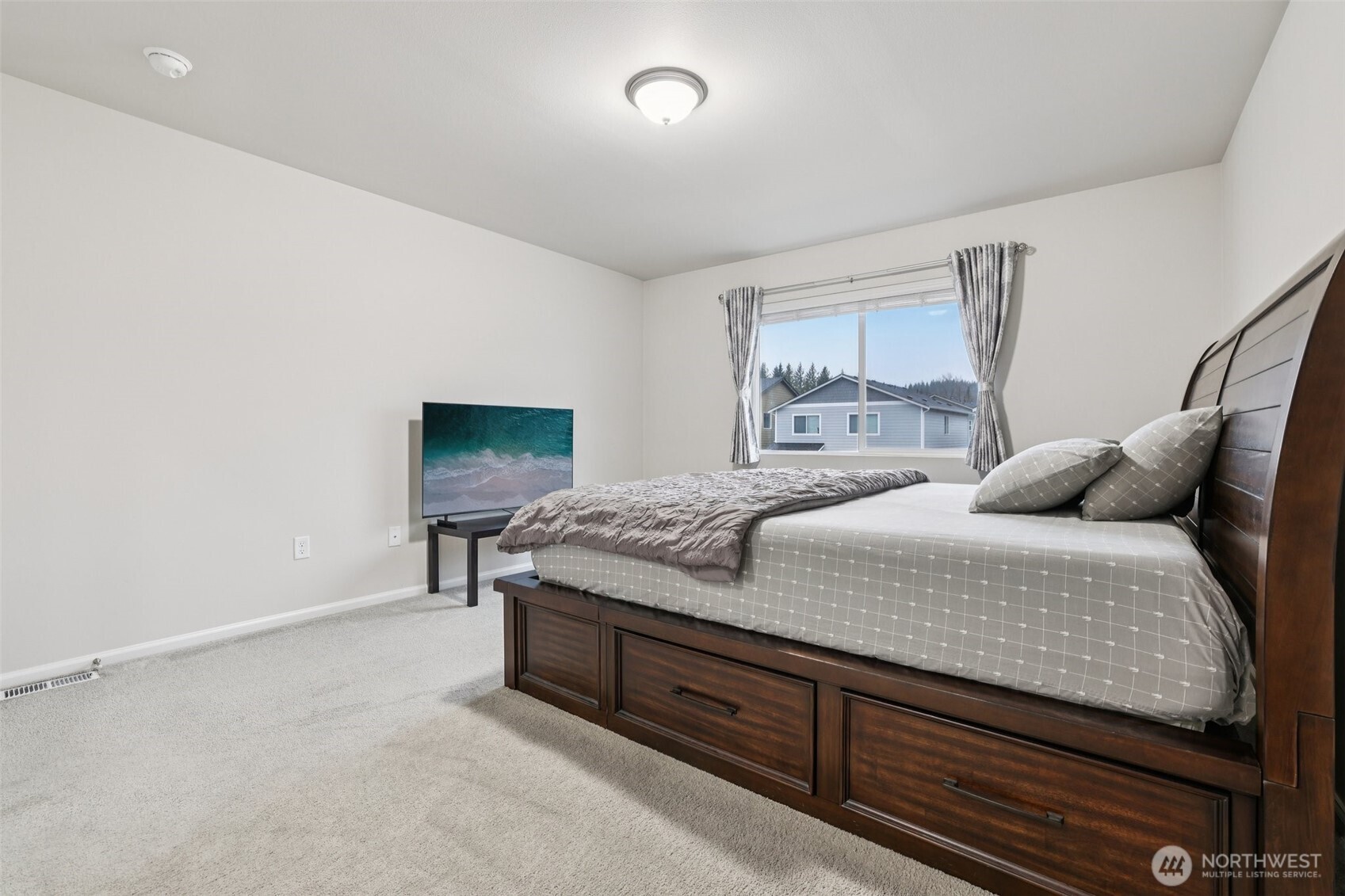 1132 15th Avenue Sultan, WA 98294 - Photo 19 of 26 a bedroom with a bed and a window