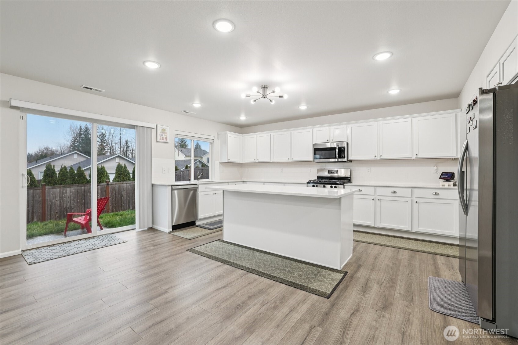 1132 15th Avenue Sultan, WA 98294 - Photo 7 of 25 a kitchen with stainless steel appliances granite countertop a refrigerator and a stove top oven