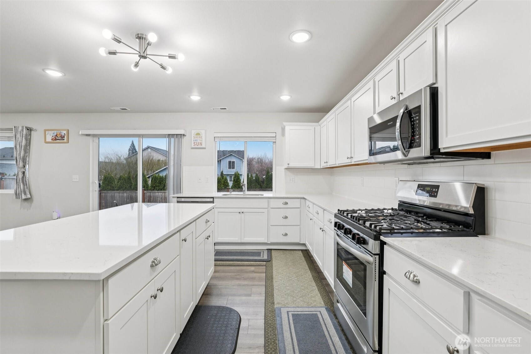 1132 15th Avenue Sultan, WA 98294 - Photo 10 of 26 a kitchen with stainless steel appliances sink stove microwave and cabinets