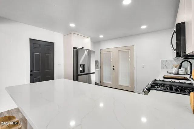 a kitchen with a stove a sink and a microwave