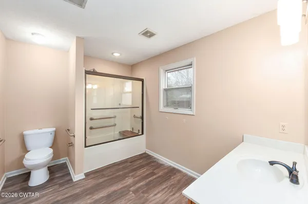 a bathroom with a toilet a sink and a mirror