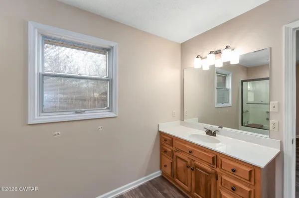 a bathroom with a sink vanity and a mirror