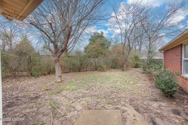 a backyard of a house with large trees