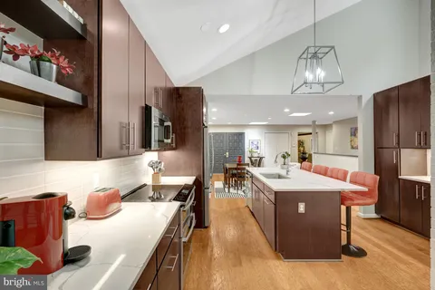 a kitchen with stainless steel appliances kitchen island granite countertop a sink and cabinets