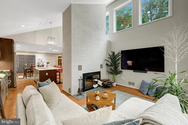 a living room with furniture a flat screen tv and a fireplace