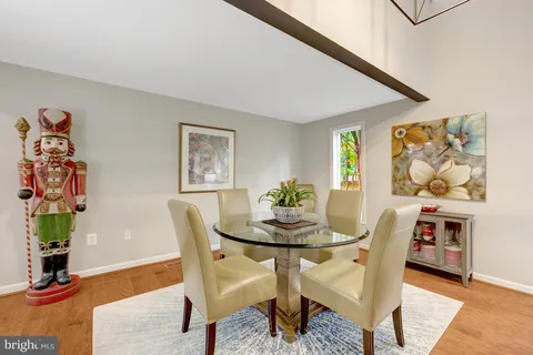a dining room with furniture and wooden floor