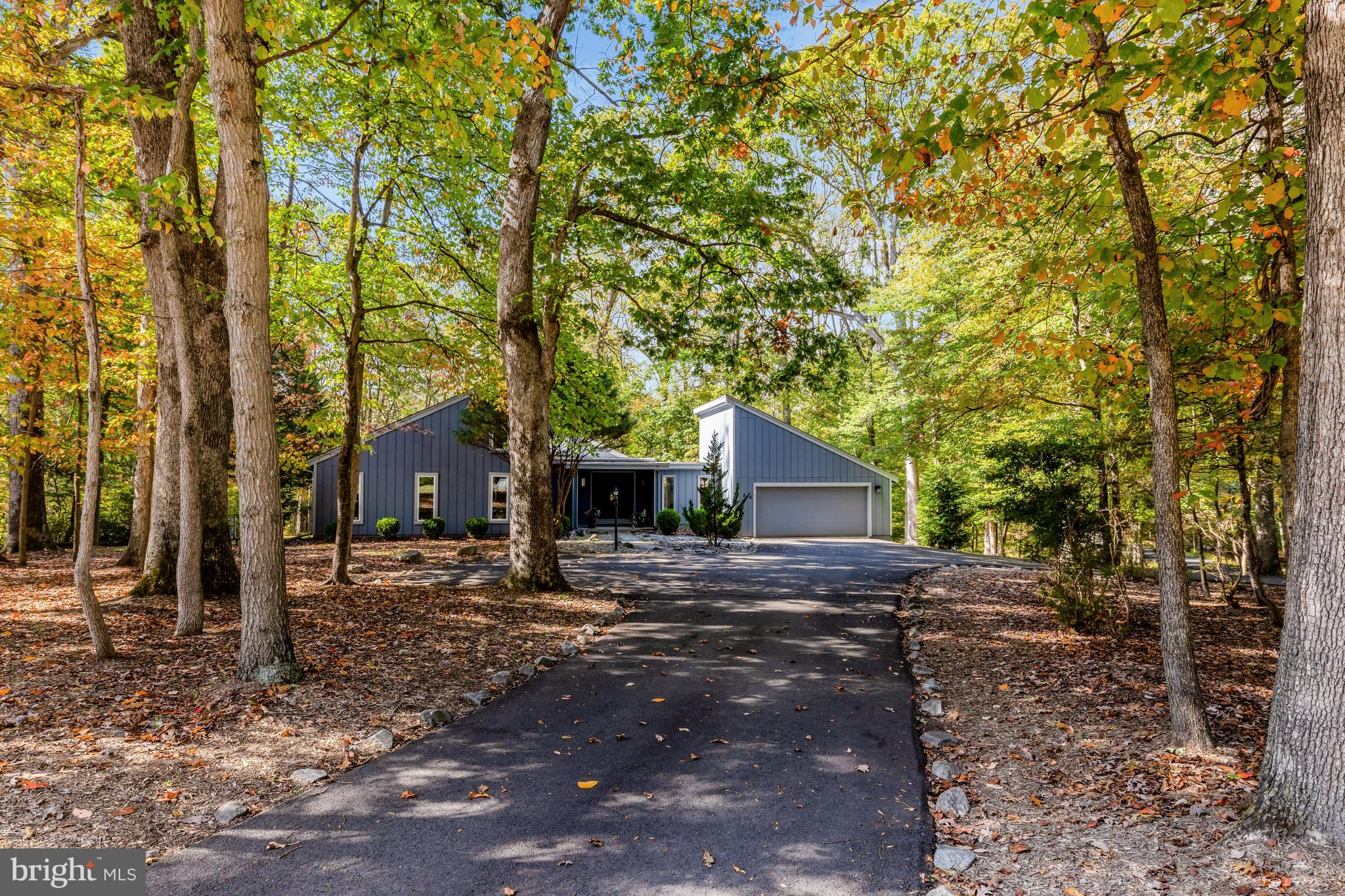 526 Springvale Road Great Falls, VA 22066 - Photo 2 of 55 a view of a old house next to a yard with large trees