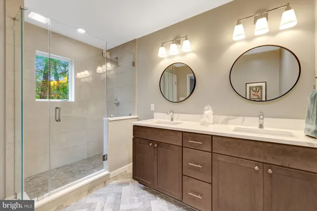 a bathroom with a double vanity sink and a mirror