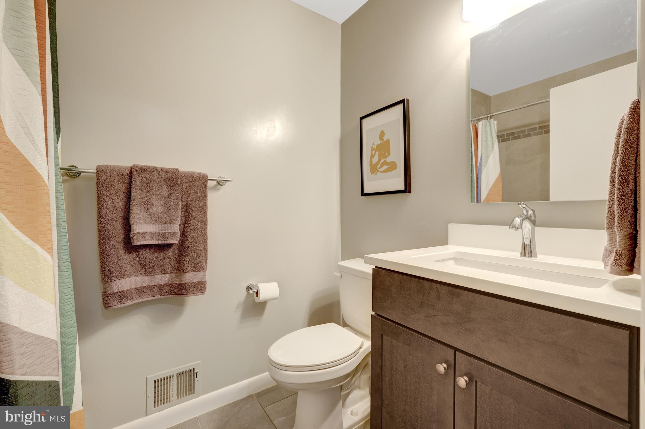 526 Springvale Road Great Falls, VA 22066 - Photo 33 of 55 a bathroom with a toilet sink vanity and mirror