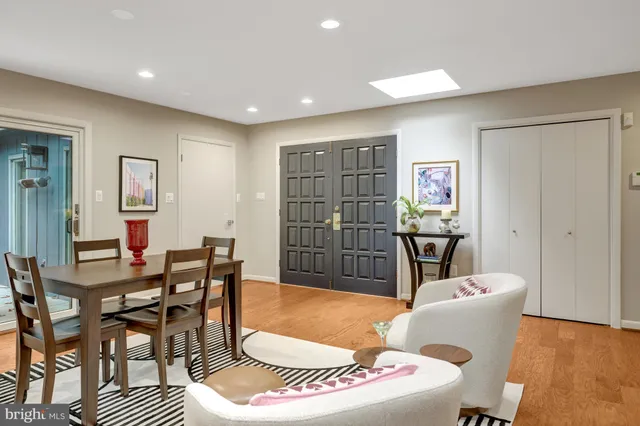 a living room with furniture a rug and a table