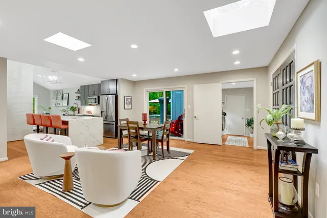 a living room with furniture a dining table and kitchen view