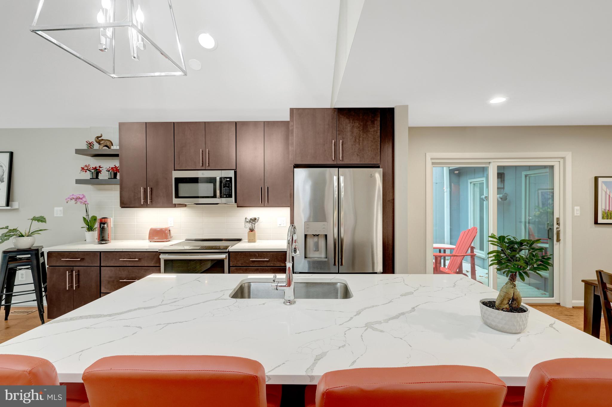 526 Springvale Road Great Falls, VA 22066 - Photo 10 of 55 a kitchen with stainless steel appliances kitchen island granite countertop a refrigerator a stove a sink dishwasher and white cabinets with wooden floor