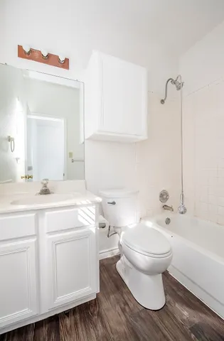 a bathroom with a toilet a sink and bathtub