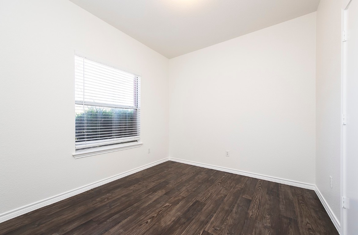 322 Tamara Drive, Unit A Georgetown, TX 78628 - Photo 16 of 17 a view of an empty room with wooden floor and a window