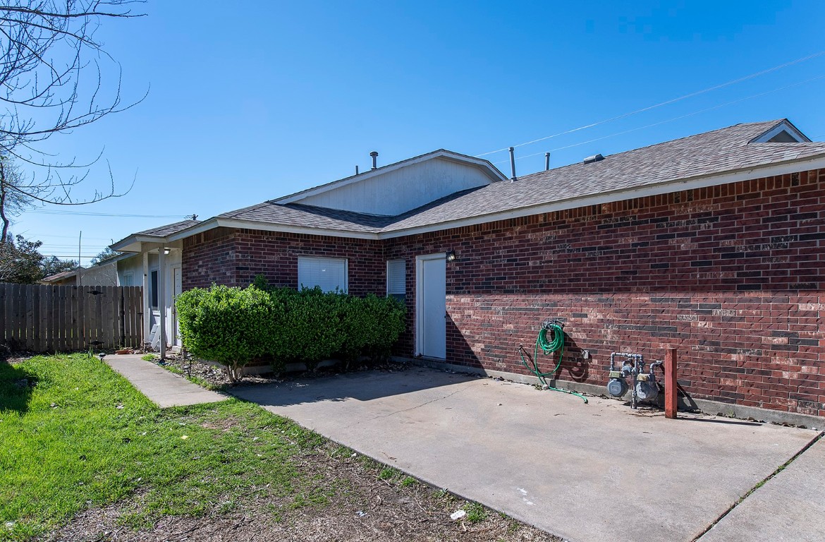 322 Tamara Drive, Unit A Georgetown, TX 78628 - Photo 3 of 17 a view of a brick house with a small yard and plants