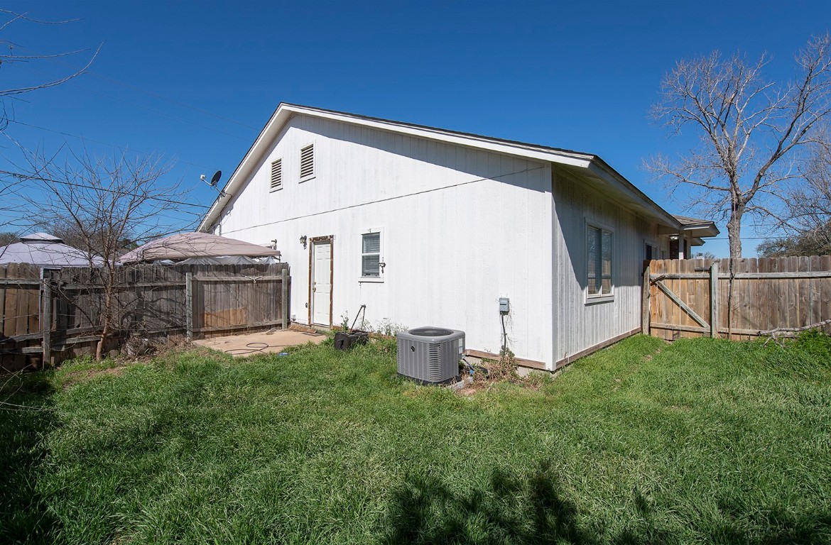 322 Tamara Drive, Unit A Georgetown, TX 78628 - Photo 4 of 17 a backyard of a house with table and chairs