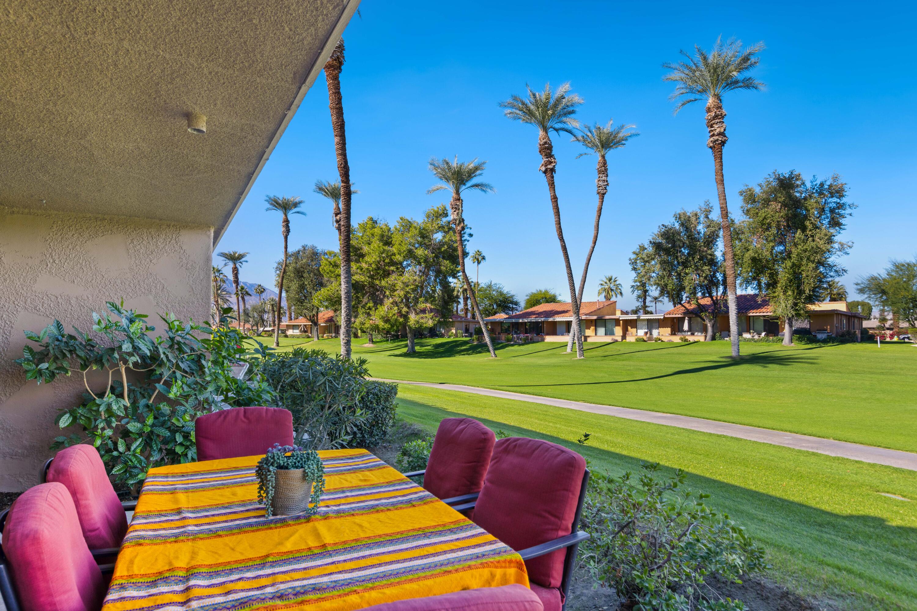 10 La Cerra Circle Rancho Mirage, CA 92270 - Photo 22 of 30 a front view of a house with swimming pool table and chairs