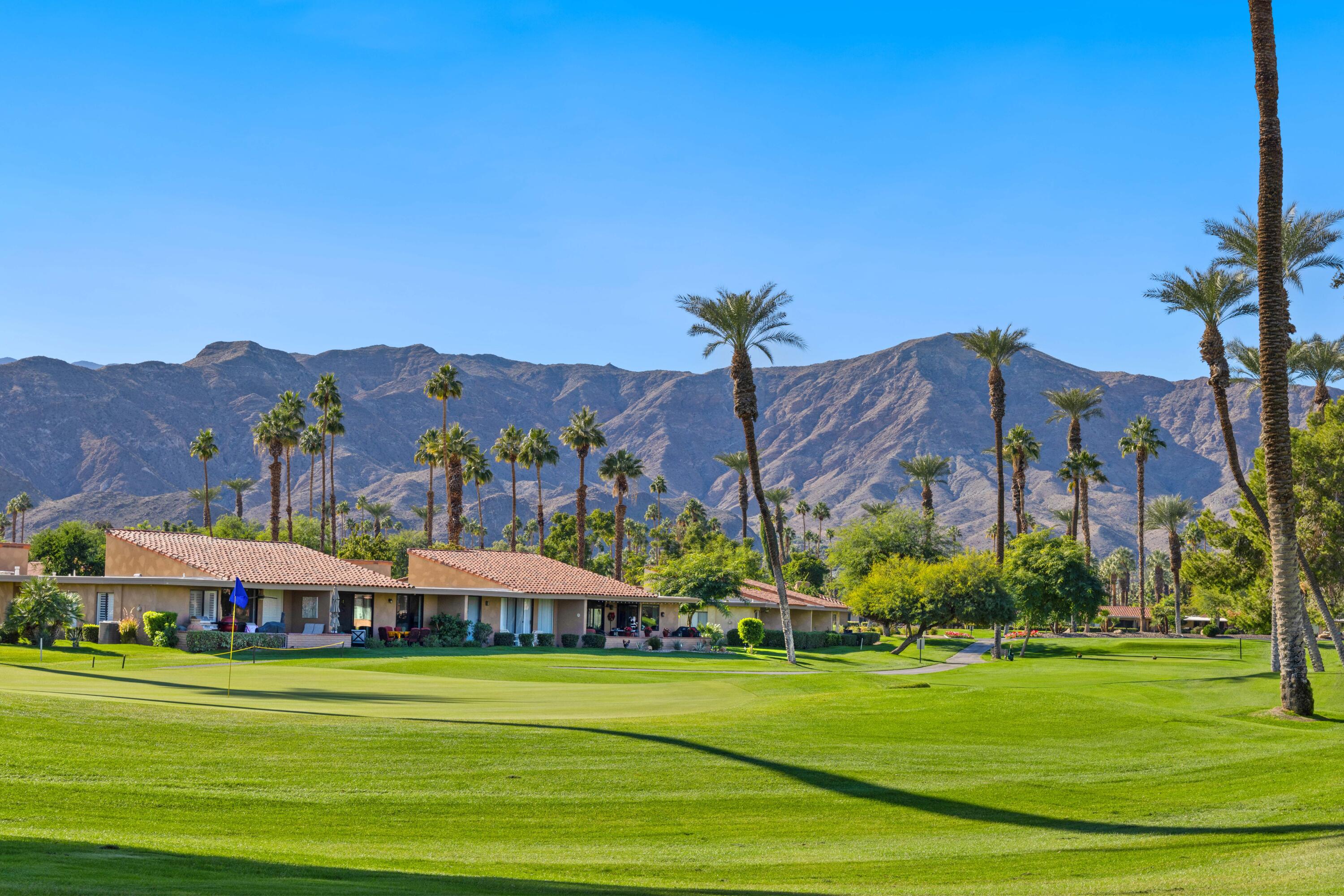 10 La Cerra Circle Rancho Mirage, CA 92270 - Photo 26 of 30 a view of a big house with a big yard and large trees