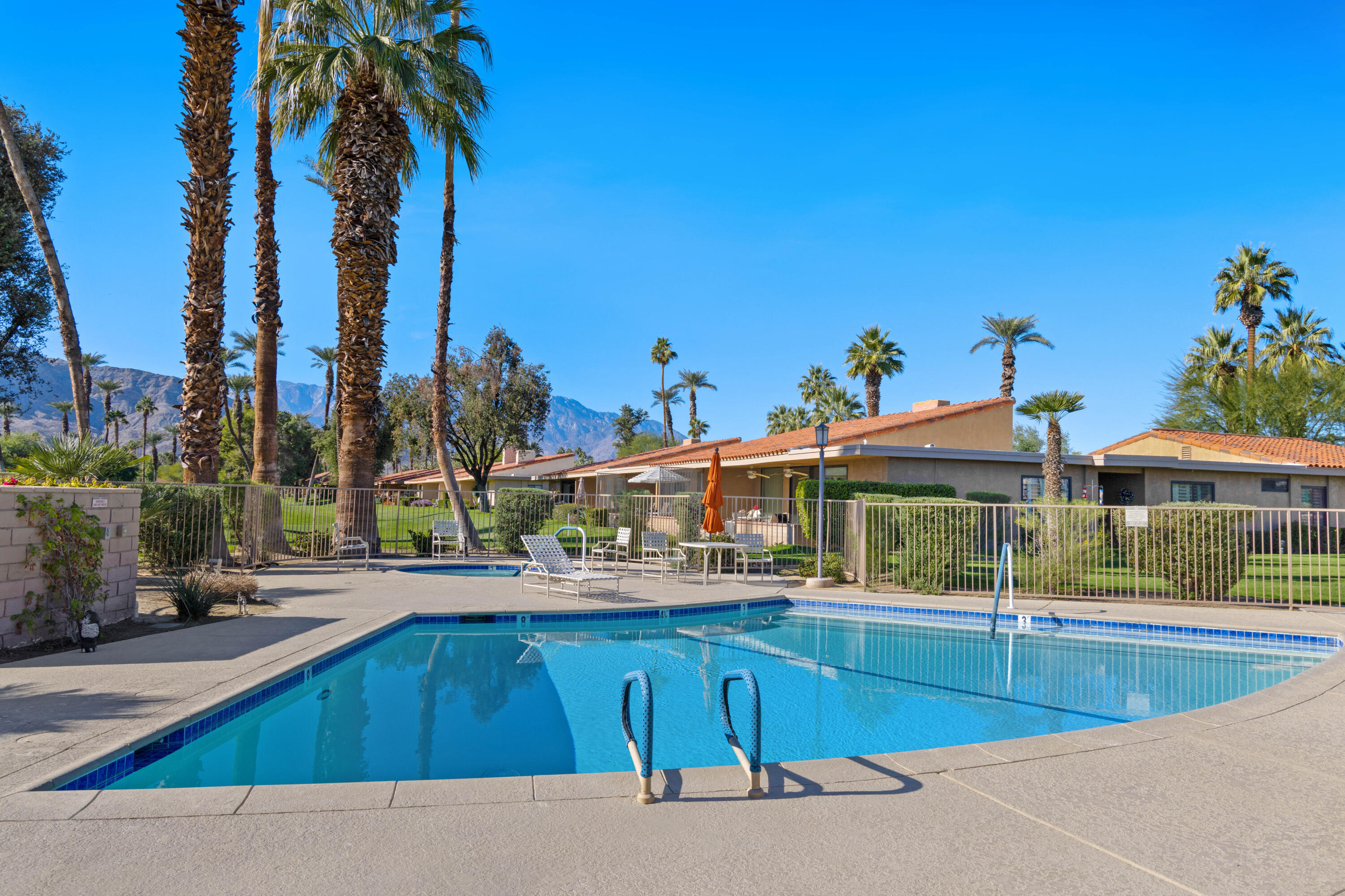 10 La Cerra Circle Rancho Mirage, CA 92270 - Photo 27 of 30 a view of a swimming pool with a lounge chairs