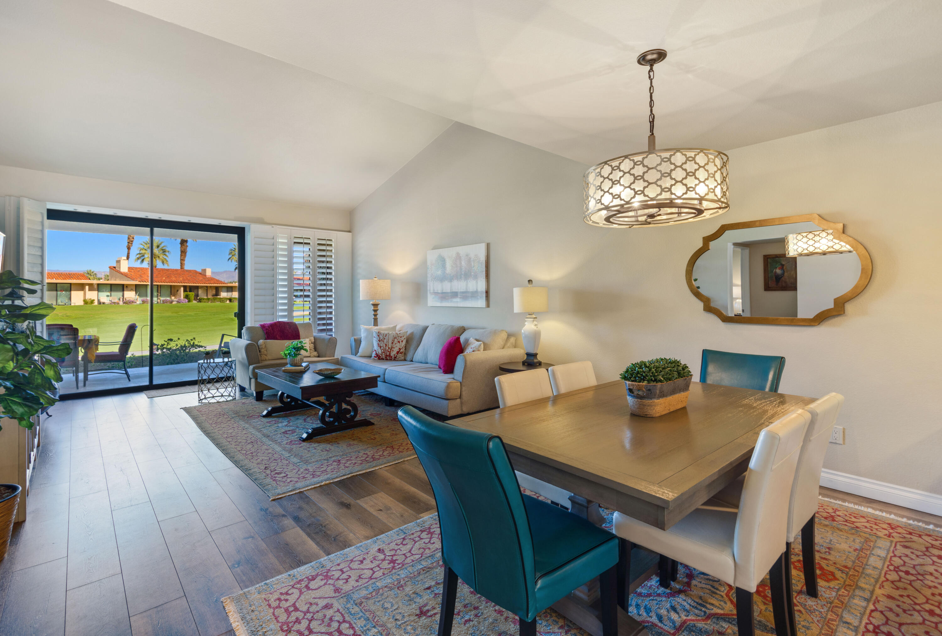 10 La Cerra Circle Rancho Mirage, CA 92270 - Photo 7 of 30 a living room with furniture a chandelier and a table