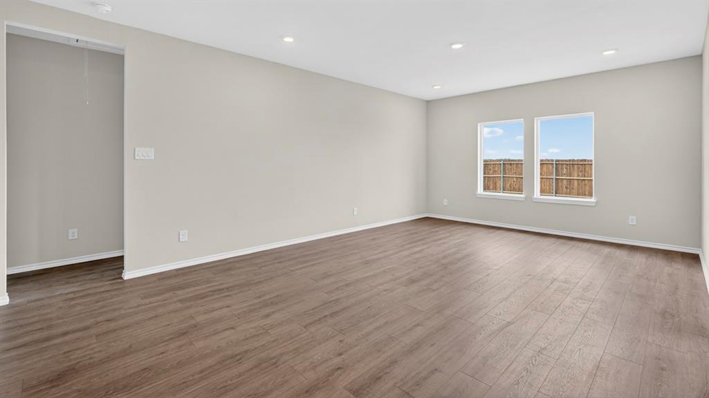 1683 Mantle Road Crandall, TX 75114 - Photo 12 of 31 Spacious room featuring wood-finish flooring, light-colored walls, white baseboards, and recessed ceiling lighting