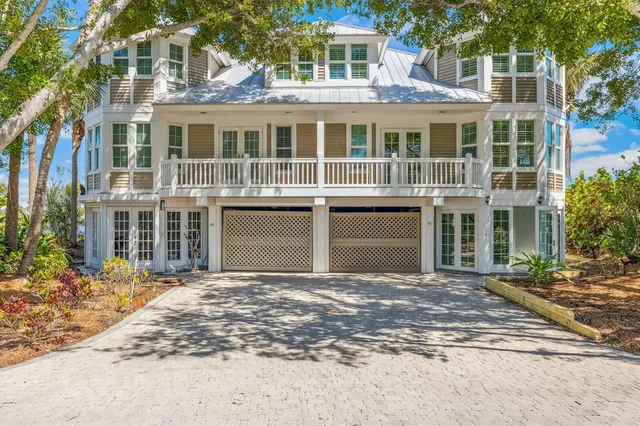 a front view of a building with a garden