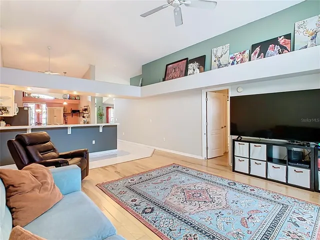 a view of a room with wooden floor and windows