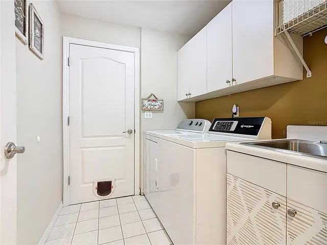 an aerial view of a house with a swimming pool outdoor seating and yard