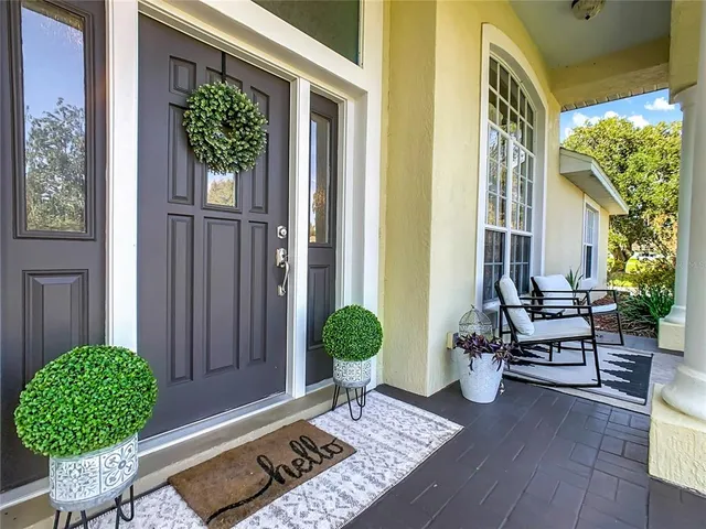 a living room with furniture a bookshelf and a large window