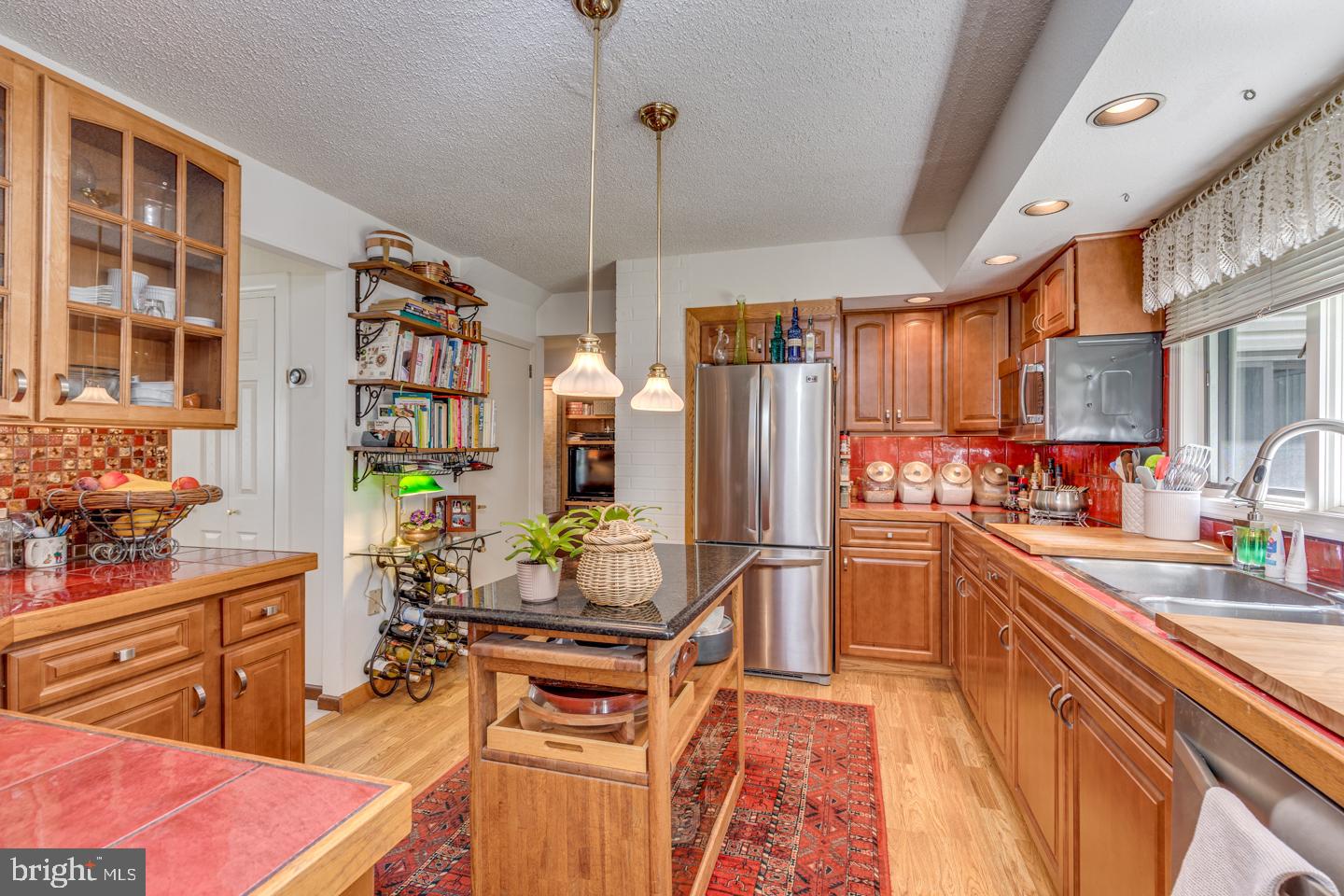 209 Harvest Road Cherry Hill, NJ 08002 - Photo 13 of 46 a kitchen with stainless steel appliances kitchen island granite countertop a refrigerator and a stove top oven