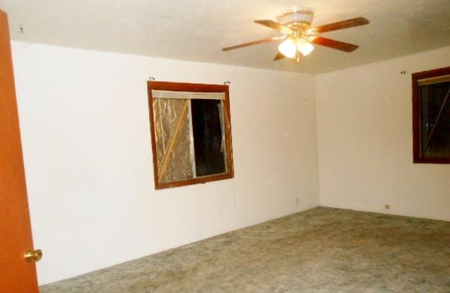 41249 Brown Road Fall River Mills, CA 96028 - Photo 11 of 19 a view of a bedroom with a ceiling fan and a window