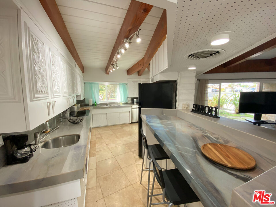 876 Center Street El Segundo, CA 90245 - Photo 27 of 32 a kitchen with a table and chairs in it