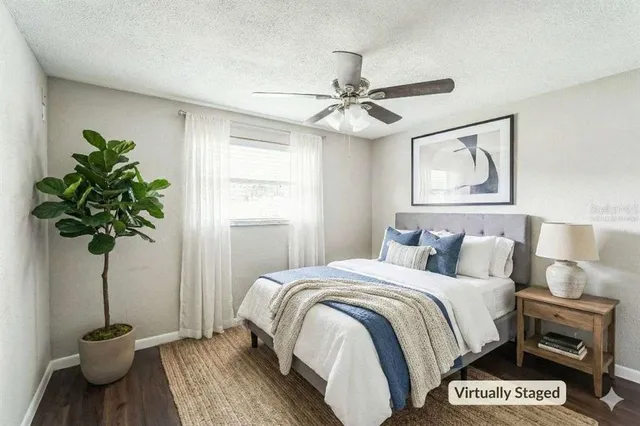 a bedroom with a bed and a potted plant