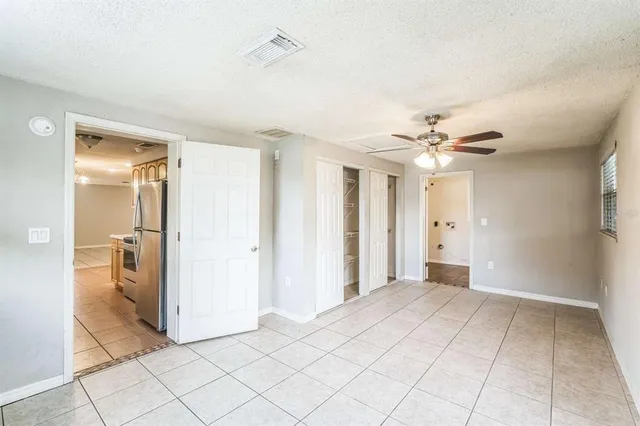 a view of a room with window and chandelier fan