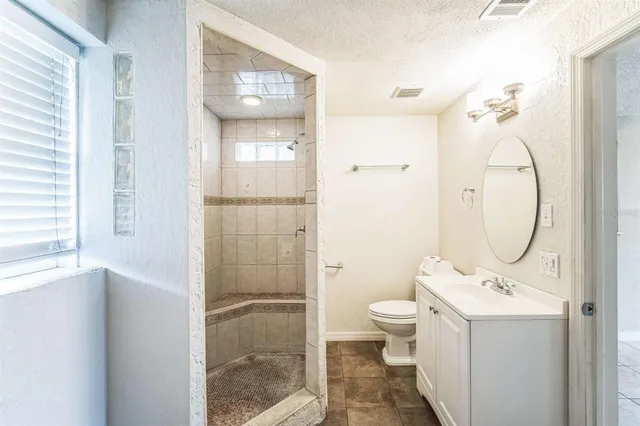 a bathroom with a toilet sink and shower
