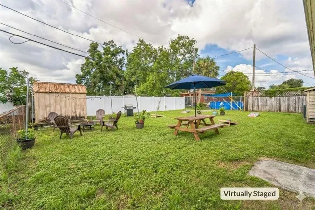 a view of a park with some trees and a wooden fence