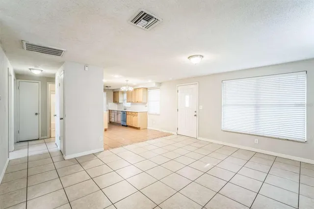 a view of an empty room and a window