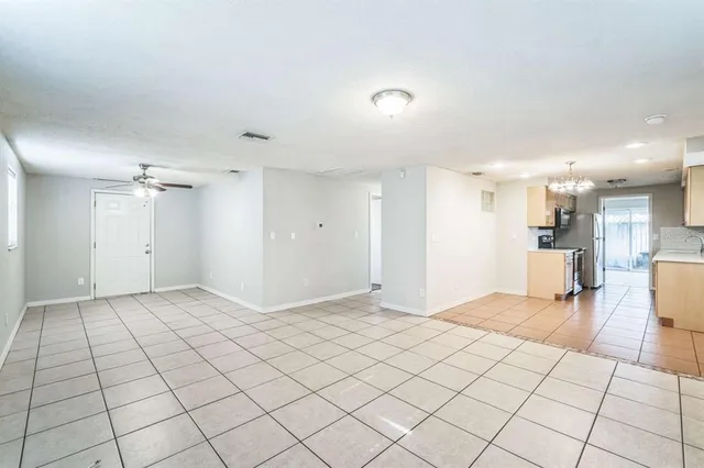 a view of a livingroom with a chandelier furniture and a large window