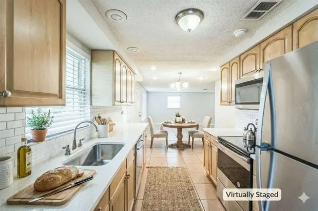 a kitchen with granite countertop a sink appliances and cabinets