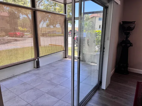 a view of empty room with wooden floor and windows