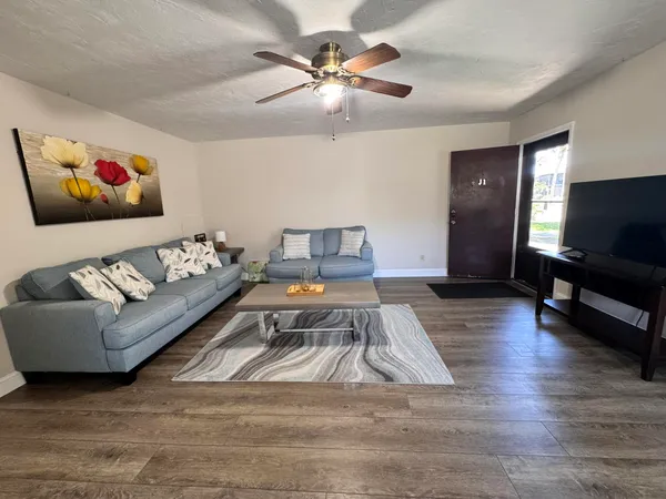 a living room with furniture and a flat screen tv