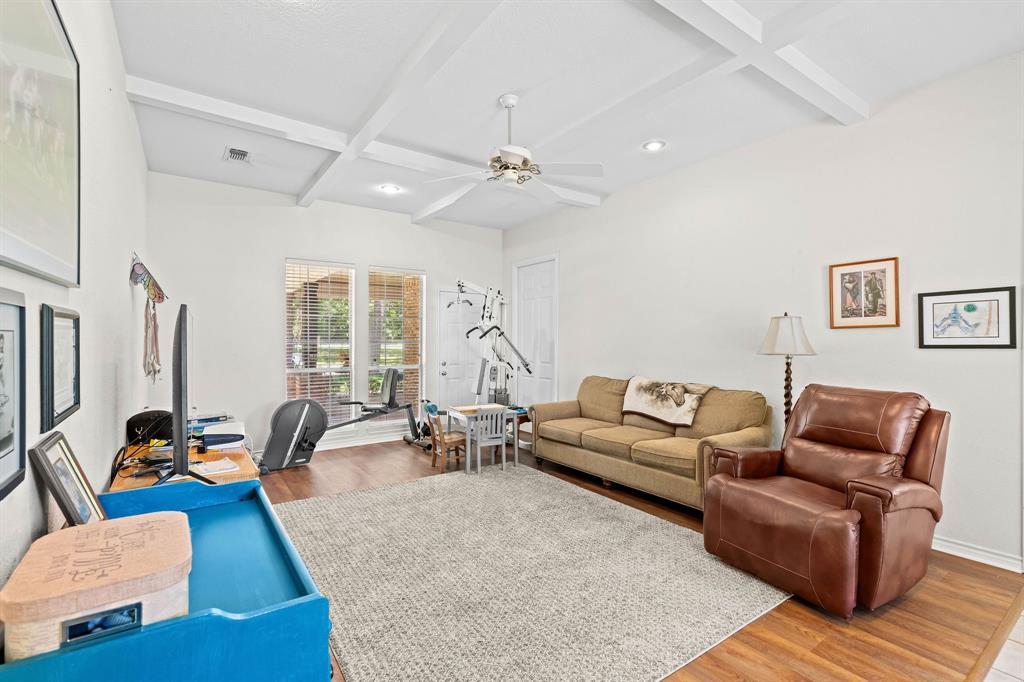 145 Indian Trail Decatur, TX 76234 - Photo 21 of 40 a living room with furniture ceiling fan and a wooden floor