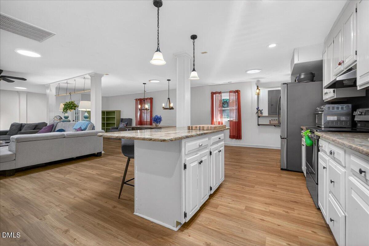 7303 Stony Hill Road Wake Forest, NC 27587 - Photo 16 of 31 a large kitchen with stainless steel appliances kitchen island granite countertop a large counter top and stainless steel appliances