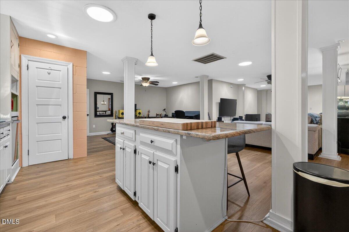 7303 Stony Hill Road Wake Forest, NC 27587 - Photo 17 of 31 a kitchen with stainless steel appliances kitchen island a refrigerator and a cabinets